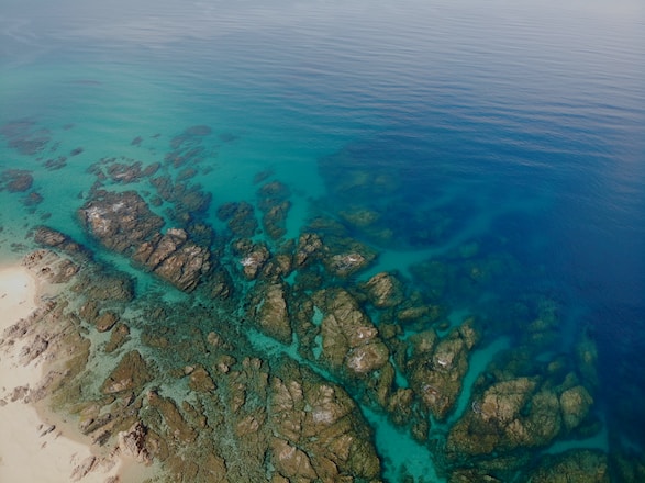 rock formations viewing sea during daytime